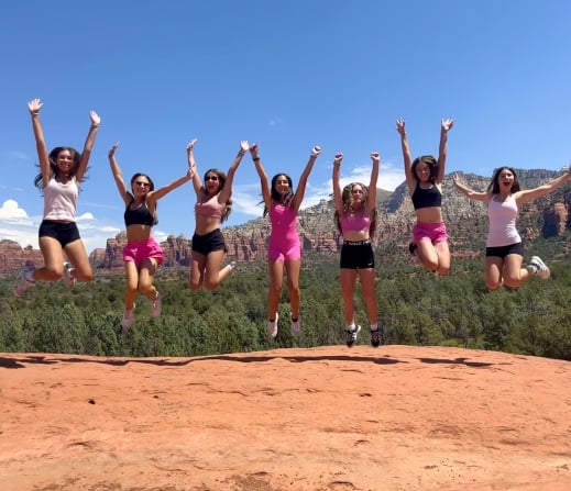 Teens jumping excitedly on a Teen Tour